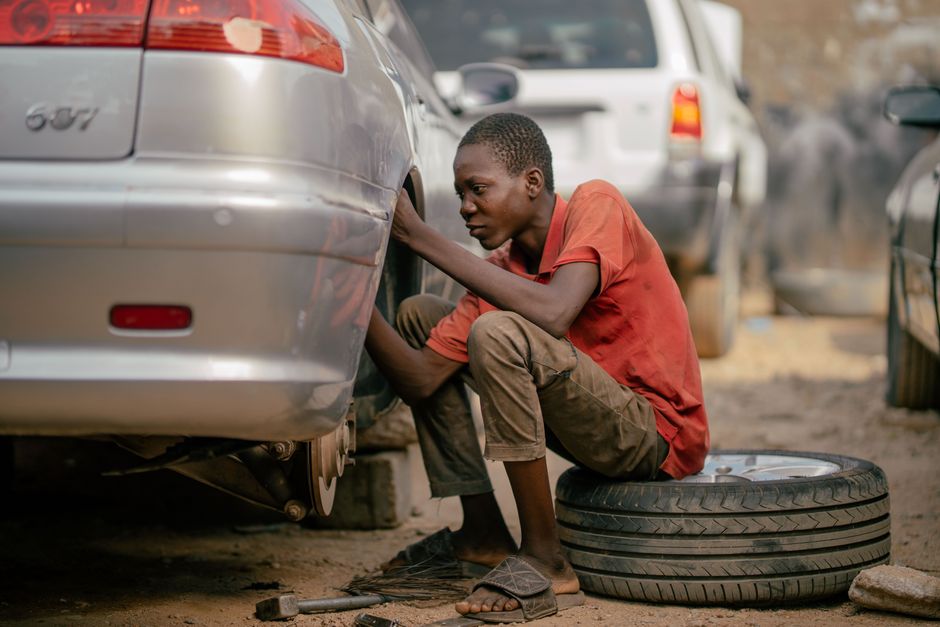 Professional mechanic changing a car tire in the shop